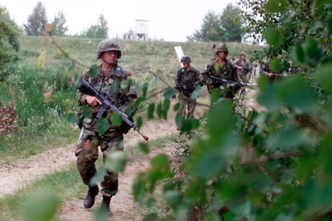 Illinois Army National Guard Sgt. Zachary Sarver leads his platoon as they conduct a route patrol during a field training portion of Exercise Peaceshield 2000 in Yavoriv, Ukraine, on July 16, 2000. Approximately 1000 soldiers from 22 countries are taking part in the peacekeeping training exercise at the Partnership for Peace Training Center at Yavoriv. Sarver is attached to Bravo Company, 2nd Battalion, 130th Infantry, Illinois Army National Guard. 