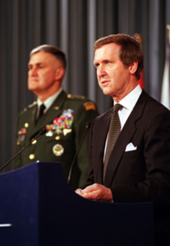 Secretary of Defense William S. Cohen (right) holds a press conference at the conclusion of the defense ministerial meetings held at NATO Headquarters in Brussels, Belgium, on June 9, 2000. Chairman of the Joint Chiefs of Staff Gen. Henry H. Shelton (left), U.S. Army, accompanied Cohen to the meetings in Brussels. 