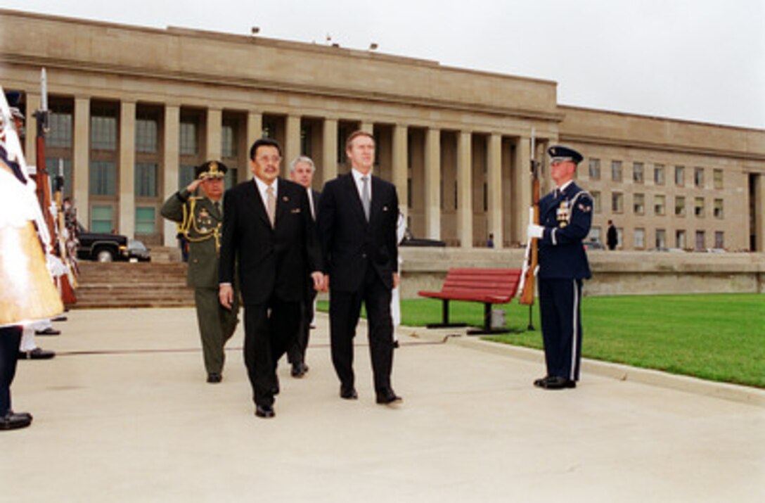 Secretary of Defense William S. Cohen (right) escorts Republic of the Philippines President Joseph Estrada (left) to the Pentagon parade field for an armed forces full honors welcoming ceremony on July 27, 2000. Cohen and Estrada will later meet to discuss security issues of interest to both nations. 