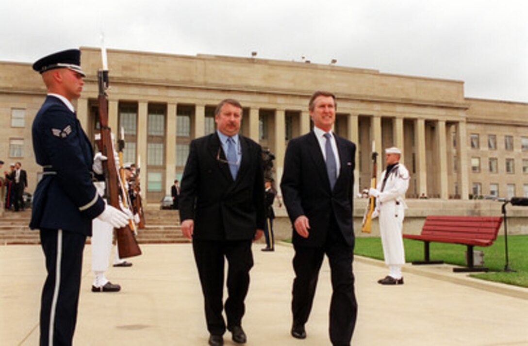 Secretary of Defense William S. Cohen (right) escorts Minister of Defense Andre Flahaut (left), of the Kingdom of Belgium, to the Pentagon River Parade Field for a welcoming ceremony in Flahaut's honor on May 23, 2000. The two men will later meet to discuss a range of security issues of interest to both nations. 
