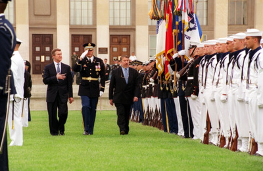 Commander of Troops Lt. Col. Charles Sniffin (center), U.S. Army, escorts Secretary of Defense William S. Cohen (left) and Minister of Defense Andre Flahaut (right), of the Kingdom of Belgium, during a Pentagon welcoming ceremony in Flahaut's honor on May 23, 2000. Cohen and Flahaut will later meet to discuss a range of security issues of interest to both nations. Sniffin is attached to the 3rd U.S. Infantry Regiment (The Old Guard), Fort Myer, Va. 