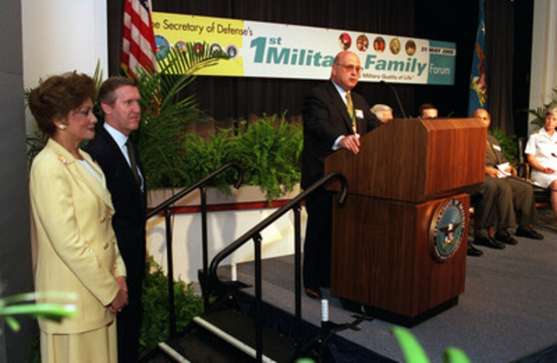 Under Secretary of Defense for Personnel and Readiness Bernard Rostker (right) introduces Secretary of Defense William S. Cohen (left) and his wife Janet Langhart Cohen at the opening session of the first annual Military Family Forum held in the Pentagon on May 31, 2000. One hundred military family members, selected from individual command areas or bases, were brought to the Pentagon to participate in the discussions devoted to military family issues. 