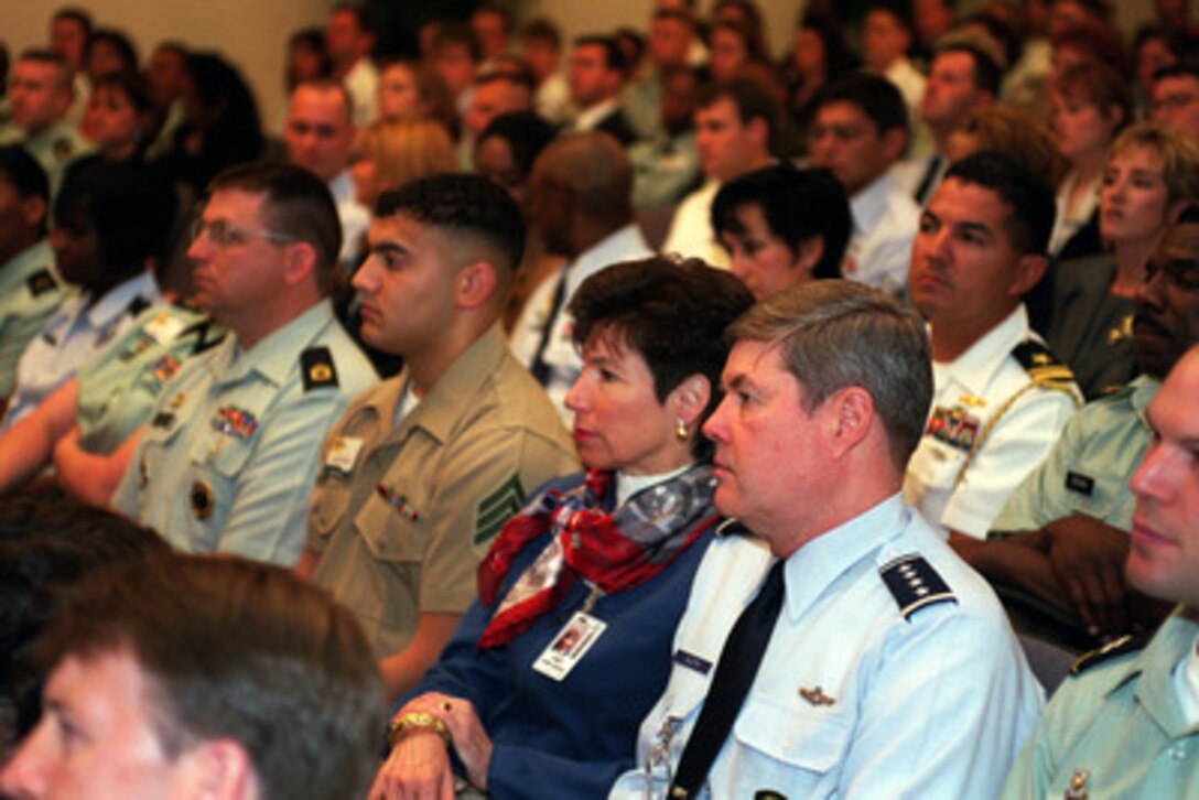 An audience of military family members, plus representatives of DoD organizations dealing with issues concerning military families, listen to remarks by Secretary of Defense William S. Cohen at the opening session of the first annual Military Family Forum held in the Pentagon on May 31, 2000. One hundred military family members, selected from individual command areas or bases, were brought to the Pentagon to participate in the discussions devoted to military family issues. Supreme Allied Commander Europe Gen. Joseph W. Ralston (right), U.S. Air Force, and his wife DeDe, attended the forum to gain a better insight into the family issues of greatest concern to the junior personnel now serving in the ranks of our armed forces. 