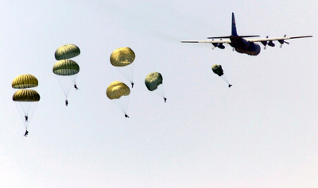 Soldiers of the 82nd Airborne Division, Fort Bragg, N.C., parachute from a C-130 Hercules during the opening ceremonies of Air Mobility Rodeo 2000 at Pope Air Force Base, N.C., on May 7, 2000. Rodeo 2000 is the U.S. Air Force Air Mobility Command's premier air mobility competition, involving more than 80 aircraft and 100 teams from 17 countries. The teams will compete in airdrops, aerial refueling, aircraft navigation, special tactics, short field landings, cargo loading, engine running on and off load, aeromedical evacuations and security forces operations. 