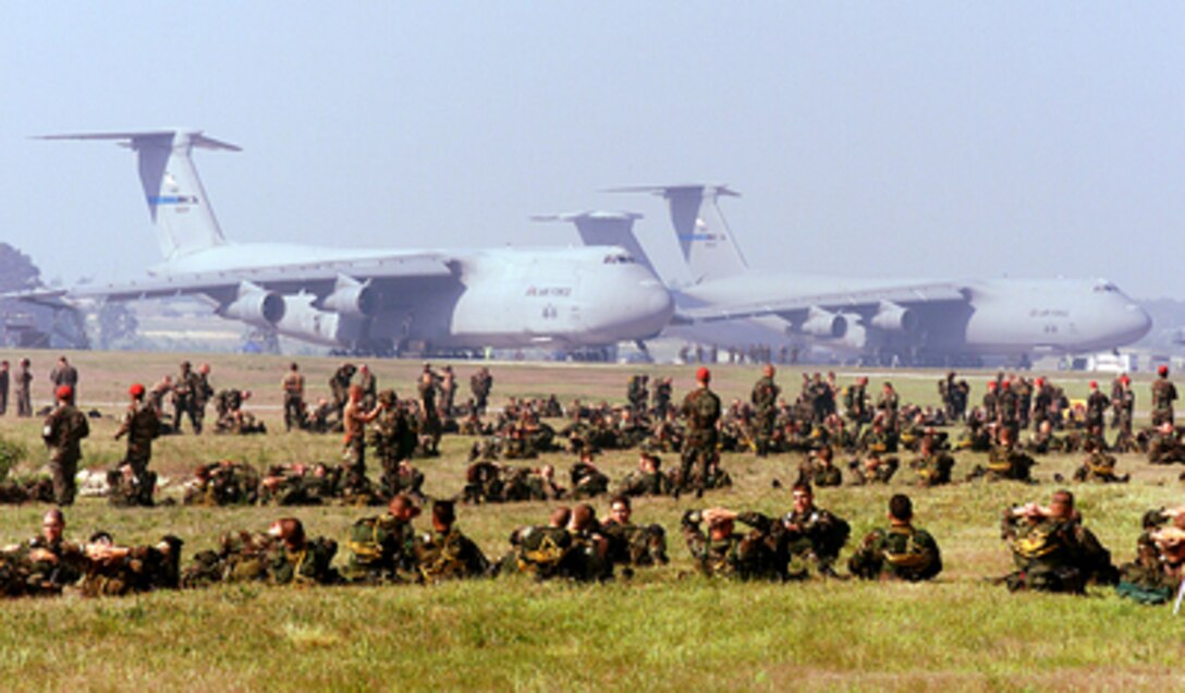 Soldiers of the U.S. Army's 82nd Airborne Division relax at Pope Air Force Base, N.C., prior to loading into aircraft for an airdrop on May 7, 2000. The paratroopers are jumping into Pope Air Force Base for the opening ceremonies of Air Mobility Rodeo 2000. Rodeo 2000 is the U.S. Air Force Air Mobility Command's premier air mobility competition, involving more than 80 aircraft and 100 teams from 17 countries. The teams compete in airdrops, aerial refueling, aircraft navigation, special tactics, short field landings, cargo loading, engine running on and off load, aeromedical evacuations and security forces operations. The 82nd is based at Fort Bragg, N.C. 