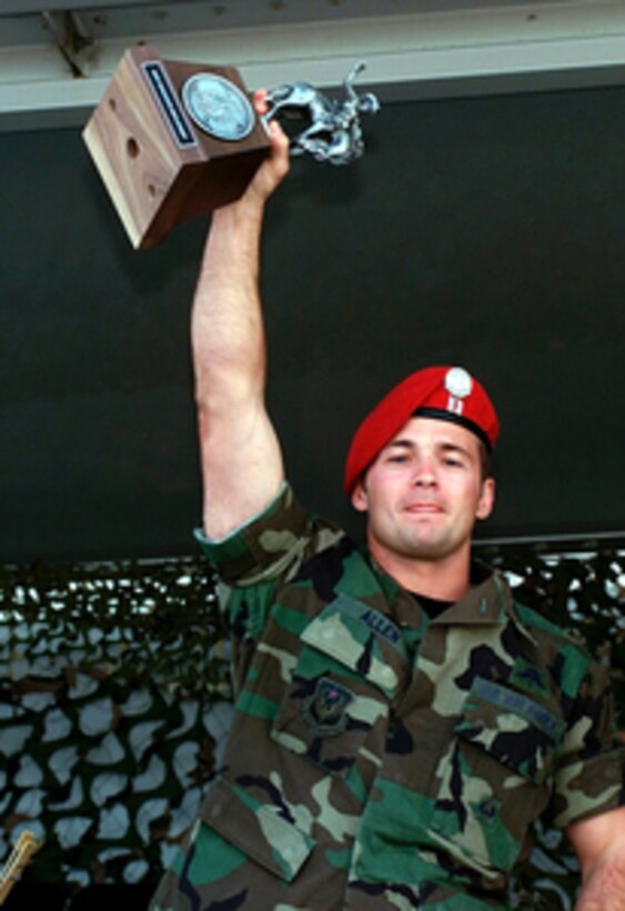 Capt. Allen, of the U.S. Air Force's 320th Special Tactics Squadron, hoists the first place trophy for the Special Tactics Parachute Employment competition of Air Mobility Rodeo 2000. Rodeo 2000 is the U.S. Air Force Air Mobility Command's premier air mobility competition, involving more than 80 aircraft and 100 teams from 17 countries. The teams compete in airdrops, aerial refueling, aircraft navigation, special tactics, short field landings, cargo loading, engine running on and off load, aeromedical evacuations and security forces operations. 
