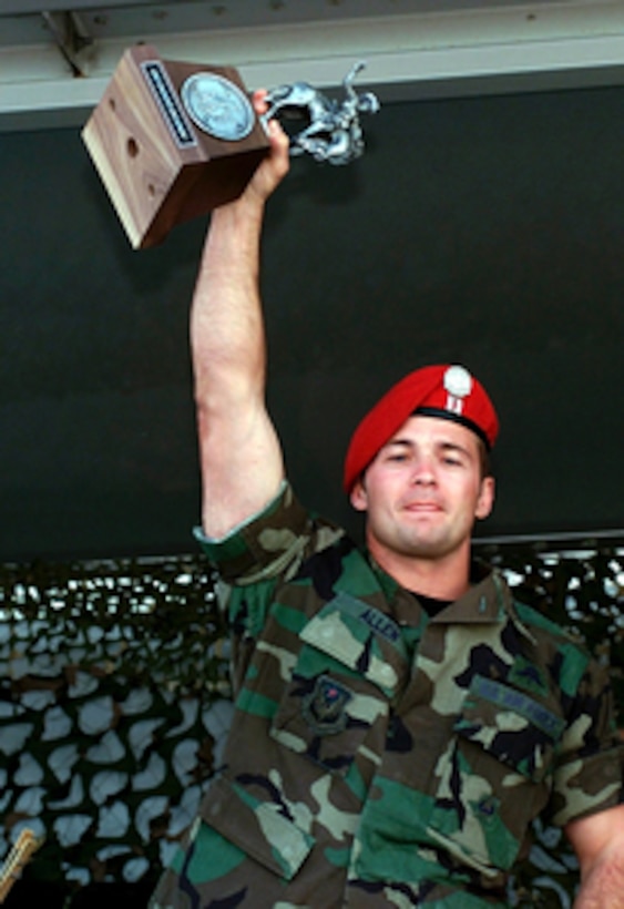 Capt. Allen, of the U.S. Air Force's 320th Special Tactics Squadron, hoists the first place trophy for the Special Tactics Parachute Employment competition of Air Mobility Rodeo 2000. Rodeo 2000 is the U.S. Air Force Air Mobility Command's premier air mobility competition, involving more than 80 aircraft and 100 teams from 17 countries. The teams compete in airdrops, aerial refueling, aircraft navigation, special tactics, short field landings, cargo loading, engine running on and off load, aeromedical evacuations and security forces operations. 