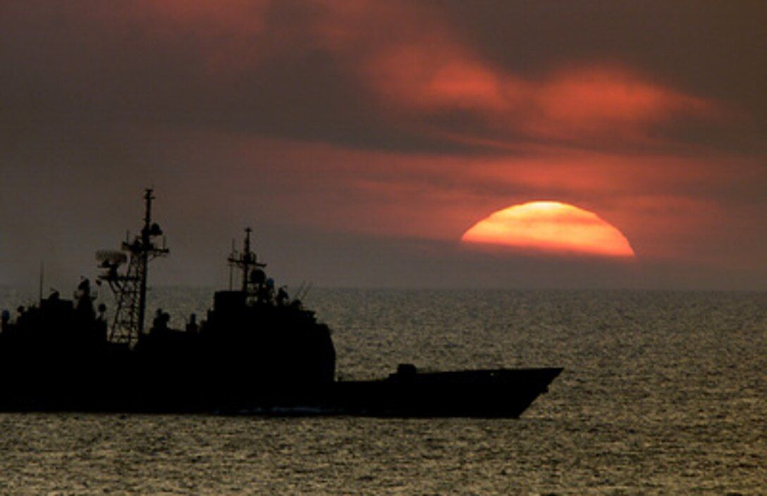 The Ticonderoga Class Cruiser USS Normandy (CG 60) steams at sunset in the Atlantic Ocean while operating with the USS George Washington battle group on May 18, 2000. The Normandy, homeported in Norfolk, Va., is participating in a Joint Task Force Exercise with the battle group. 