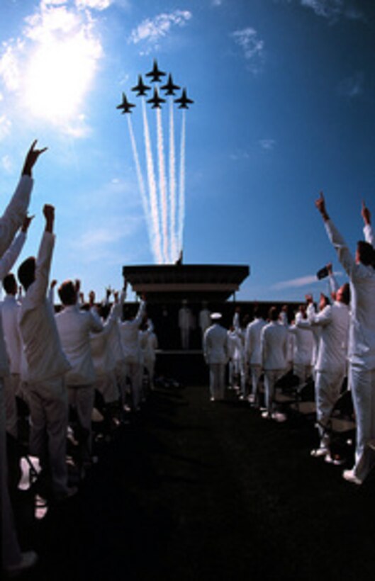 The U.S. Naval Academy's graduating class of 2000 cheers as the F/A-18 Hornets of the Blue Angels flight demonstration team streak across the sky during graduation ceremonies in Annapolis, Md., on May 24, 2000. 