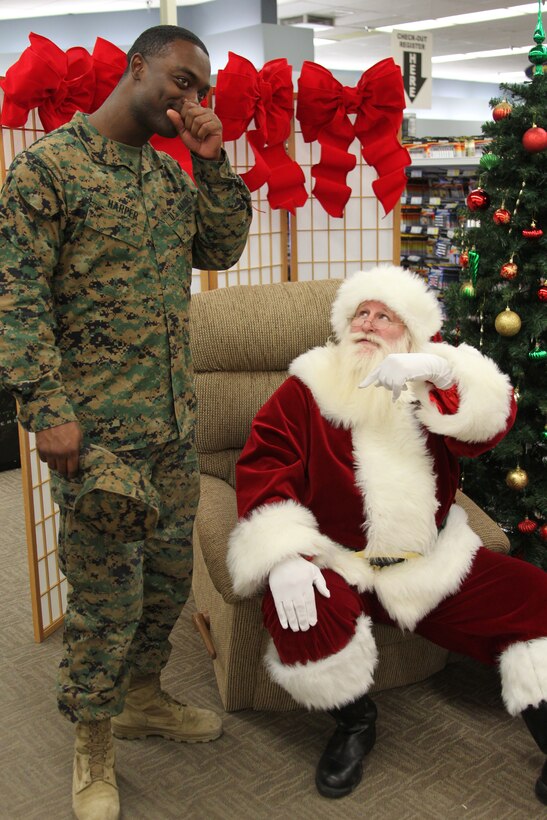 Santa Claus jokingly threatens to tell Lance Cpl. Willie Harper’s superiors if he does not take a picture with him Dec. 1, 2010, during the Single Marine Shopping Night at the Marine Corps Exchange.