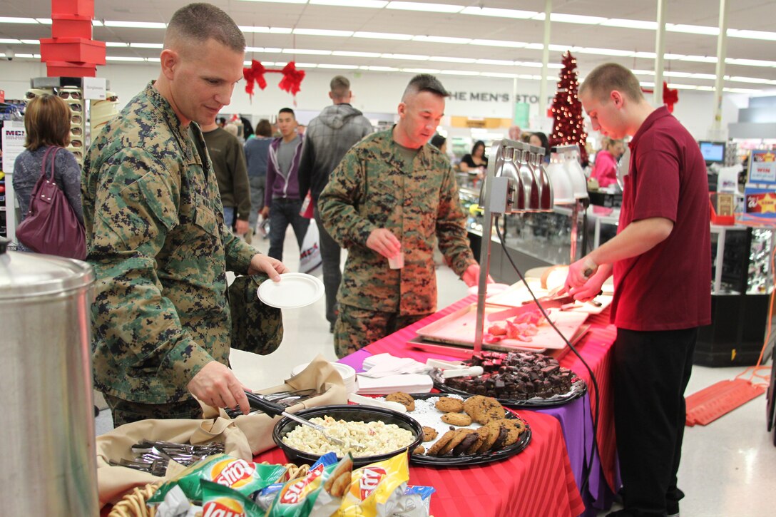Sergeant Maj. James Walsh and Master Gunnery Sgt. Douglas Webster enjoy the festivities and the buffet during the Single Marines Shopping Night Dec. 1, 2010, at the Marine Corps Exchange.::r::::n::