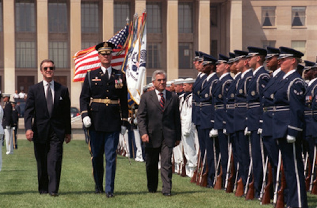 Chilean Minister of Defense Mario Fernandez (right) inspects the joint services honor guard during a full honor arrival ceremony hosted by Secretary of Defense William S. Cohen (left) at the Pentagon on June 2, 2000. Escorting the two defense leaders is the Commander of Troops Col. Charles Sniffin (center), U.S. Army. 