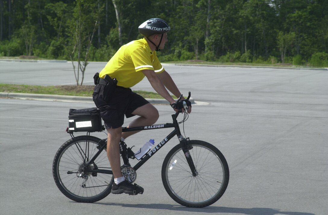 MARINE CORPS BASE CAMP LEJEUNE, N.C. - Cpl. Lon P. Roberson, a military policeman with the Bike Patrol, patrols a parking lot while on duty here June 15. The Provost Marshal's Office has recently restarted its Bike Patrol unit, which began in May and will continue till the fall. (Official U.S. Marine Corps photo by Lance Cpl. Brandon R. Holgersen)