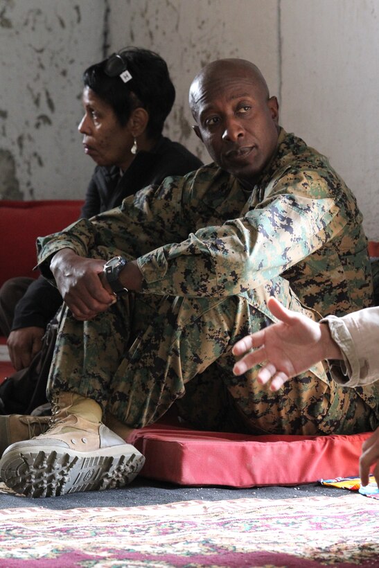 Sergeant Major of the Marine Corps Sgt. Maj. Carlton Kent sits with role players in an Afghan house while visiting 3rd Battalion, 2nd Marine Regiment, out o fCamp Lejeune, N.C., at Range 210 during the unit's Enhanced Mojave Viper training Dec. 6, 2010.::r::::n::