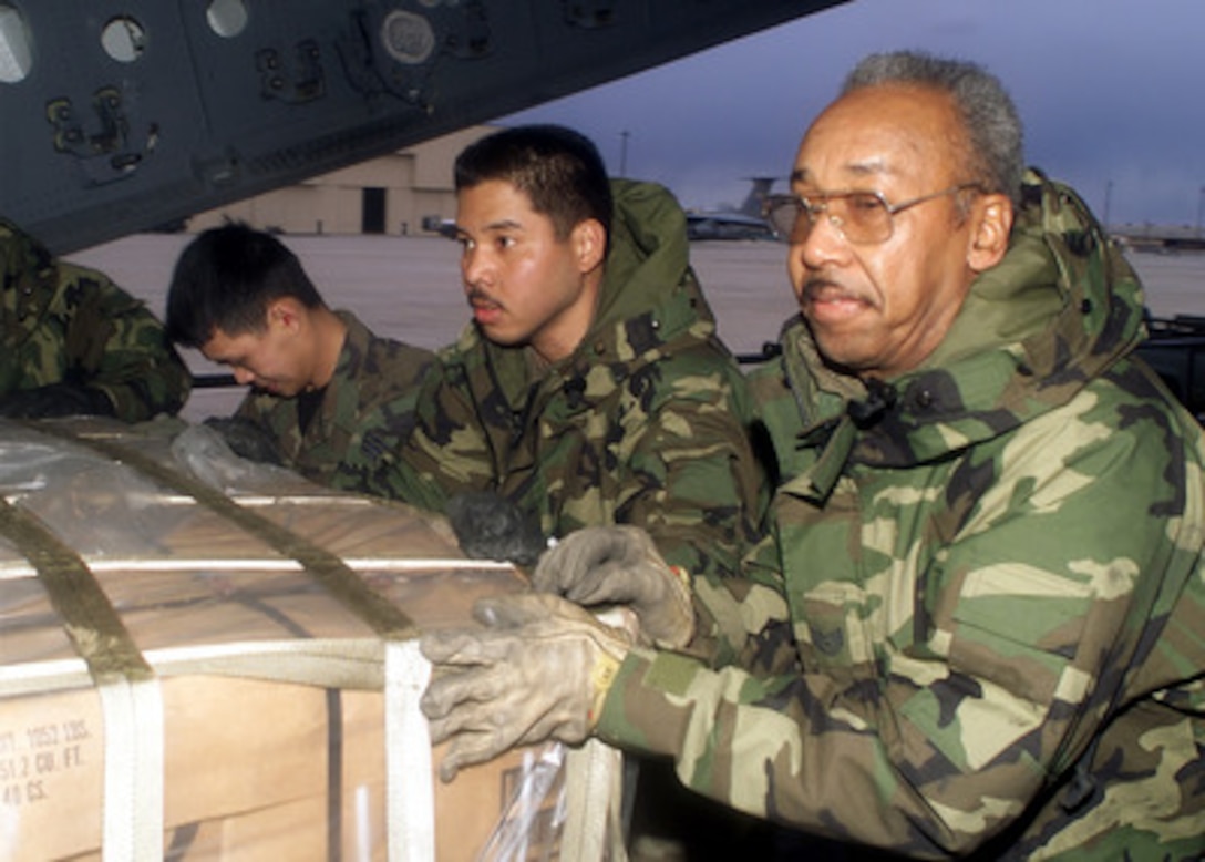 Tech. Sgt. Henry Jernigan (right), Senior Airmen James Lin (center) and Sang Tran (left), push a pallet of cargo aboard a U.S. Air Force C-17 Globemaster III at McGuire Air Force, N.J., on March 2, 2000. The aircraft is en route to South Africa as part of Operation Atlas Response. Atlas Response is the U.S. military's contribution to relief efforts following torrential rains and flooding in southern Mozambique and South Africa. About 30 airmen from the 621st Air Mobility Operations Group are deploying to South Africa to set up and maintain airfield operations for the humanitarian operation. 