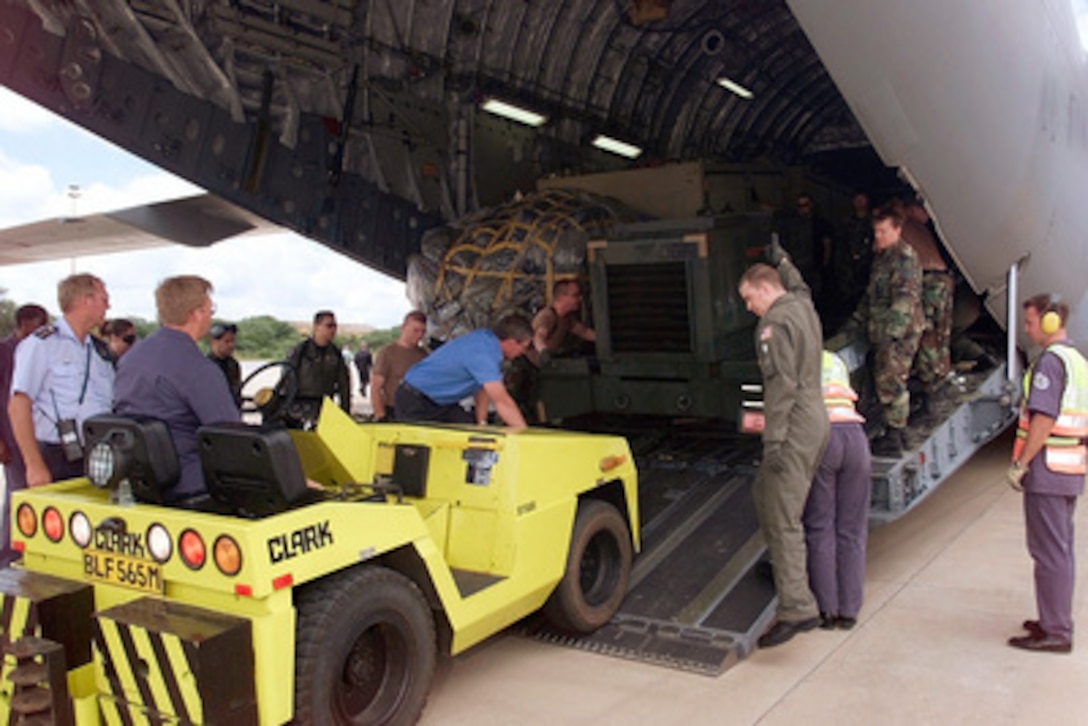 A ground crew from South Africa and a U.S. Air Force C-17A Globemaster III flight crew from Charleston Air Force Base, S.C., work together to unload a generator at Hoedspruit Air Force Base, South Africa, on March 5, 2000. The crew of the C-17A Globemaster III is delivering personnel and cargo to Hoedspruit for Operation Atlas Response. Operation Atlas Response is the U.S. military's contribution to relief efforts following torrential rains and flooding in southern Mozambique and South Africa. The C-17A is the first of several flights that will bring helicopters and military personnel to assist with search and rescue and with the distribution of relief supplies. 
