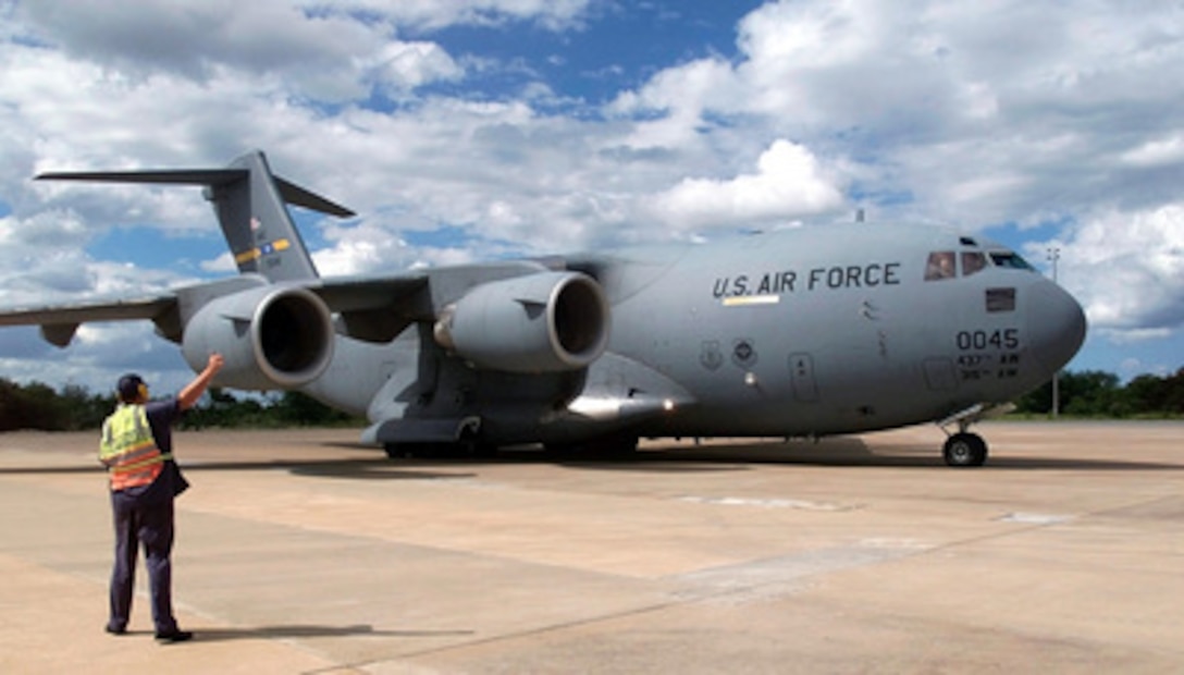 A U.S. Air Force C-17A Globemaster III is given the thumbs-up to taxi for departure from Hoedspruit Air Force Base, South Africa, on March 5, 2000. The crew of the C-17A Globemaster III delivered personnel and cargo to Hoedspruit for Operation Atlas Response. Operation Atlas Response is the U.S. military's contribution to relief efforts following torrential rains and flooding in southern Mozambique and South Africa. The C-17A is the first of several flights that will bring helicopters and military personnel to assist with search and rescue and with the distribution of relief supplies. The Globemaster III is deployed for the operation from the 437th Airlift Wing, Charleston Air Force Base, S.C. 