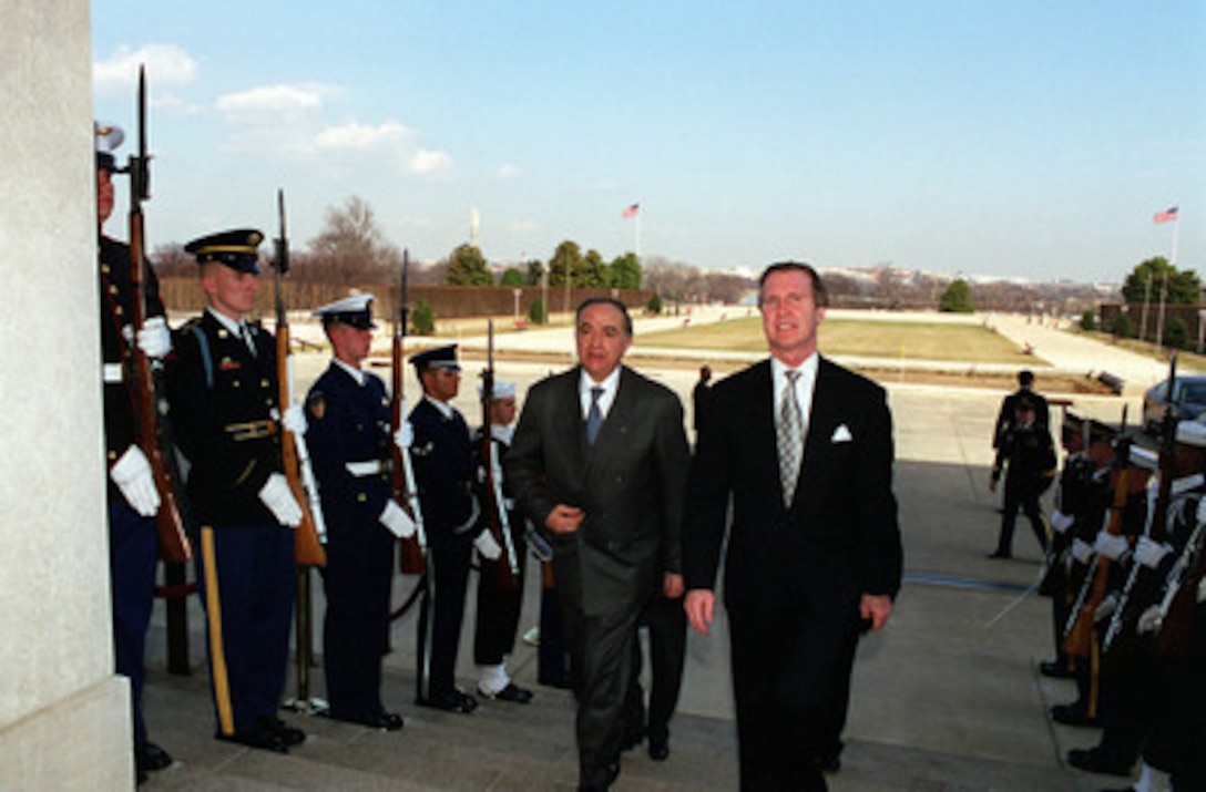 Secretary of Defense William S. Cohen (right) escorts Minister of Foreign Affairs Habib Ben Yahia (left), of the Republic of Tunisia, through an honor cordon and into the Pentagon on Feb. 25, 2000. The two men and their senior advisors will meet to discuss a range of regional security issues of interest to both nations. 