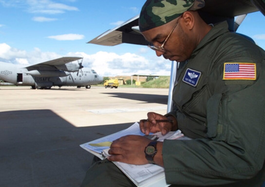 C-130 Hercules Loadmaster Tech. Sgt. Fred Hall checks aircraft weight and balance sheets prior to departing Hoedspruit Air Force Base, South Africa, on March 8, 2000, to deliver U.S. personnel and supplies to Beira, Mozambique, during Operation Atlas Response. Operation Atlas Response is the U.S. military's contribution to relief efforts following torrential rains and flooding in southern Mozambique and South Africa. Hall is deployed to South Africa from the 37th Airlift Squadron, 86th Airlift Wing, Ramstein Air Base, Germany. 