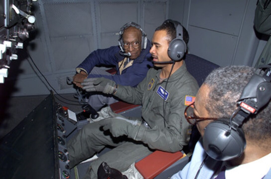 Airman Darius Hunter-Woodley (center) is flanked by two Tuskegee Airmen as he operates the refueling boom of his KC-10 Extender to refuel a C-141 Starlifter on Feb. 10, 2000. Members of the 32nd Air Refueling Squadron had the Tuskegee Airmen as their guests during a mid-air refueling orientation flight originating at McGuire Air Force Base, N.J. 