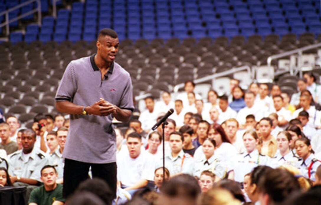 San Antonio Spurs' player David Robinson, a graduate of the U.S. Naval Academy, speaks about his experiences in the Navy to Junior ROTC cadets at the Alamo Dome, March 3, 2000. Robinson was able to provide many personal insights on how his experiences in the military had helped him develop the attitude and personality traits that lead him to success in other aspects of his life. 