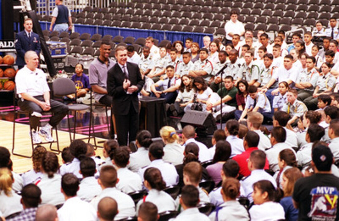 Secretary of Defense William S. Cohen addresses a gathering of Junior ROTC cadets from area high schools at the Alamo Dome in San Antonio, Texas, on March 3, 2000. Cohen was joined by Spurs' Head Coach Gregg Popovich (left), a graduate of the U.S. Air Force Academy and San Antonio Spurs' player David Robinson (right), a graduate of the U.S. Naval Academy at Annapolis, who were able to provide many personal insights on how their experiences in the military had helped them develop the attitudes and personality traits that lead them to success in other aspects of their lives. 