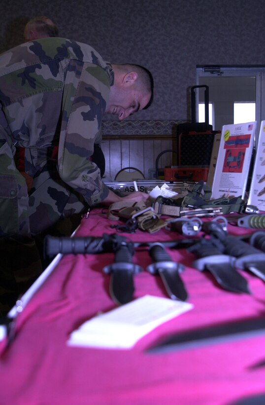 MARINE CORPS BASE CAMP LEJEUNE, N.C. - A Marine fills out a raffle ticket for a free knife at the Ontario Knife Company exhibit, where various new or improved knives and bayonets were displayed at the Annual Technology Exposition at Marston Pavilion March 16. The Armed Forces Communications and Electronics Association hosted the exposition and displayed over 30 manufacturing companies, each with their share of the latest state-of-the-art technology. (Official Marine Corps photo by Lance Cpl. Matthew K. Hacker)