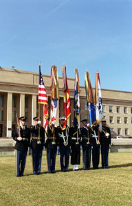 The Joint Service Color Guard waits for its cue to march onto the Pentagon River Parade Field during an armed forces welcoming ceremony on March 7, 2000. 