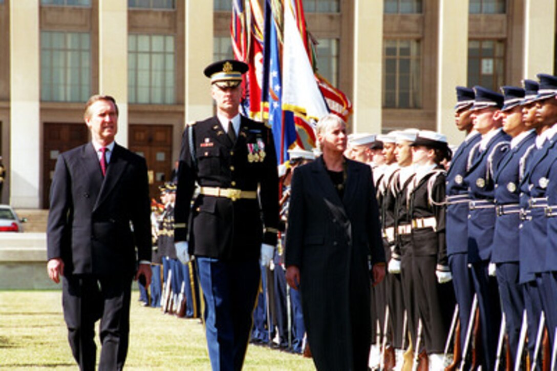Secretary of Defense William S. Cohen (left) and Minister of Defense Eldbjorg Lower (right), of the Kingdom of Norway, are escorted by Commander of Troops Lt. Col. Charles Sniffin (center), U.S. Army, as Lower inspects the troops during an armed forces welcoming ceremony at the Pentagon on March 7, 2000. 