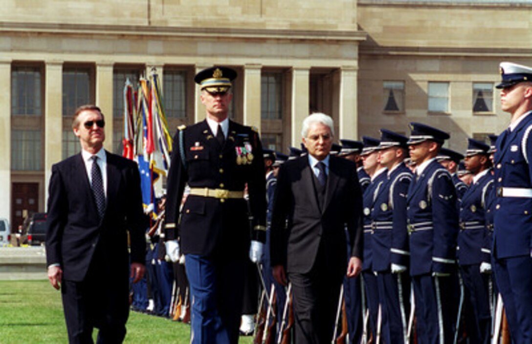 Commander of Troops Lt. Col. Charles Sniffin (center), U.S. Army, escorts Secretary of Defense William S. Cohen (left) and his guest Minister of Defense Sergio Mattarella (right), of Italy, as Mattarella inspects the troops during an armed forces welcoming ceremony at the Pentagon on March 23, 2000. Sniffin is attached to the 3rd U.S. Infantry Regiment (The Old Guard). 