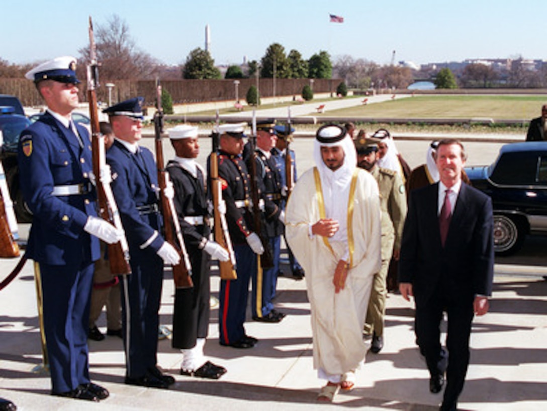Sheikh Jasim bin Hamad bin Khalifa Al Thani (left), crown prince of the State of Qatar, is escorted by Secretary of Defense William S. Cohen through an honor cordon into the Pentagon on March 6, 2000. The two men will meet to discuss a range of security issues of interest to both nations. 