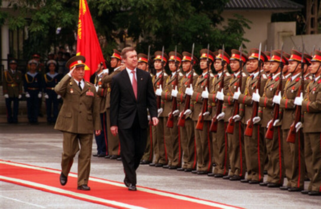Vietnamese Defense Minister Lt. Gen. Pham Van Tra (left) escorts Secretary of Defense William S. Cohen (right) as he inspects the troops during an armed forces honors ceremony at the Ministry of Defense Guest House in Hanoi, Vietnam, on March 13, 2000. Cohen is the first U.S. defense secretary to visit Vietnam since the end of the Vietnam War in 1975. 