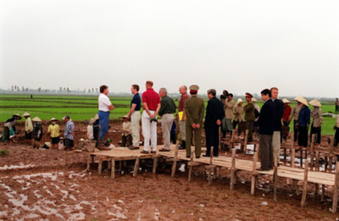 Anthropologist Denny Danielson (left) briefs Secretary of Defense William S. Cohen (in blue shirt) on the painstaking process of the search and recovery of the remains of U.S. servicemen unaccounted for from the Vietnam War at a crash excavation site near Hanoi, Vietnam, on March 13, 2000. Cohen traveled to the site to see firsthand the efforts being made and the process involved in the search and recovery of the remains of U.S. servicemen unaccounted for during the Vietnam War. According to an eyewitness account, a Navy F-4B Phantom crashed at the site in May 1967. Danielson is assigned to the Central Identification Laboratory in Hawaii. 