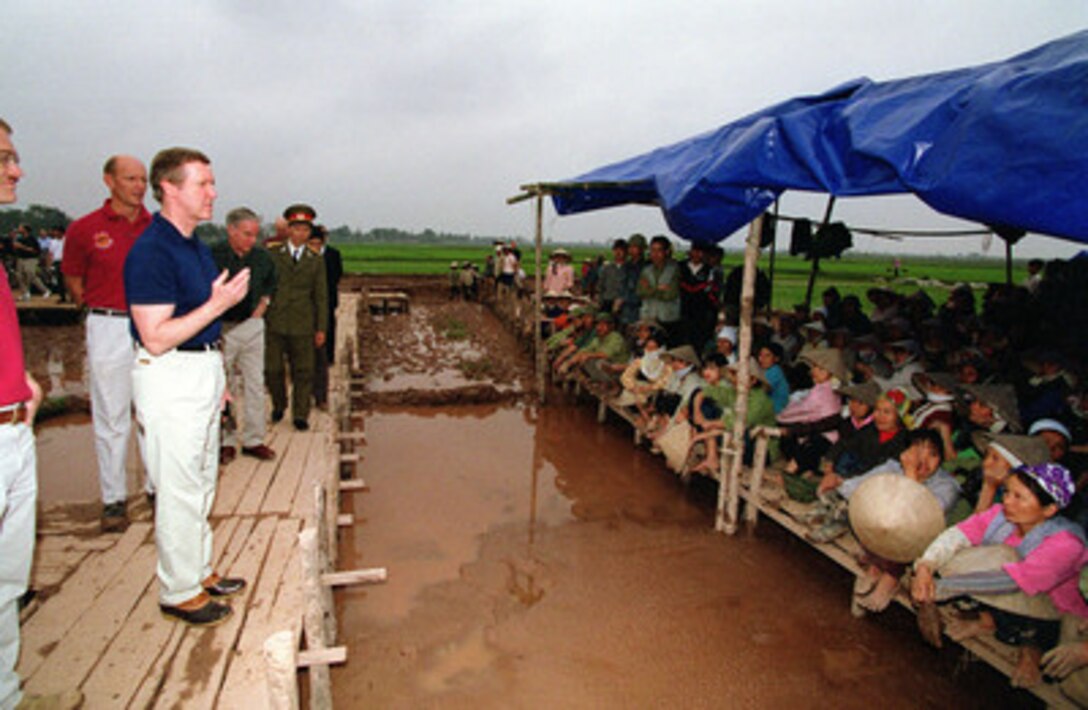 Secretary of Defense William S. Cohen (left) thanks the Vietnamese villagers for their cooperation and work in the painstaking process of the search and recovery of the remains of U.S. servicemen unaccounted for from the Vietnam War at a crash excavation site near Hanoi, Vietnam, on March 13, 2000. Cohen traveled to the site to see firsthand the efforts being made and the process involved in the search and recovery of the remains of U.S. servicemen unaccounted for during the Vietnam War. According to an eyewitness account, a Navy F-4B Phantom crashed at the site in May 1967. 