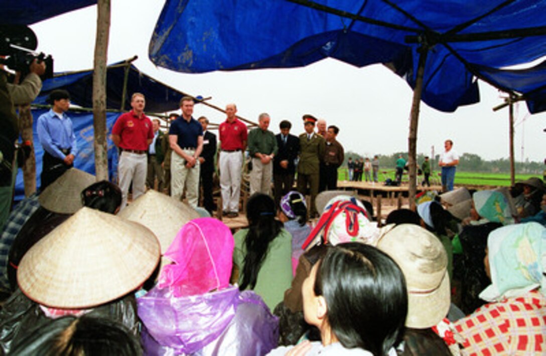 Secretary of Defense William S. Cohen (3rd from left) waits for the translator as he thanks the Vietnamese villagers for their cooperation and work in the painstaking process of the search and recovery of the remains of U.S. servicemen unaccounted for from the Vietnam War at a crash excavation site near Hanoi, Vietnam, on March 13, 2000. Cohen traveled to the site to see firsthand the efforts being made and the process involved in the search and recovery of the remains of U.S. servicemen unaccounted for during the Vietnam War. According to an eyewitness account, a Navy F-4B Phantom crashed at the site in May 1967. 