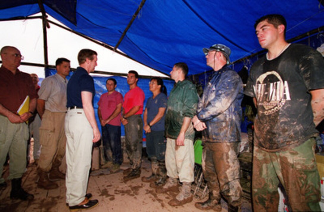 Secretary of Defense William S. Cohen (3rd from left) thanks some members of Joint Task Force Full Accounting for their painstaking and often dirty work in the search and recovery of remains of U.S. servicemen unaccounted for during the Vietnam War at a crash excavation site near Hanoi, Vietnam, on March 13, 2000. Cohen traveled to the site to see firsthand the efforts being made and the process involved in the search and recovery of the remains of U.S. servicemen unaccounted for during the Vietnam War. According to an eyewitness account, a Navy F-4B Phantom crashed at the site in May 1967. 
