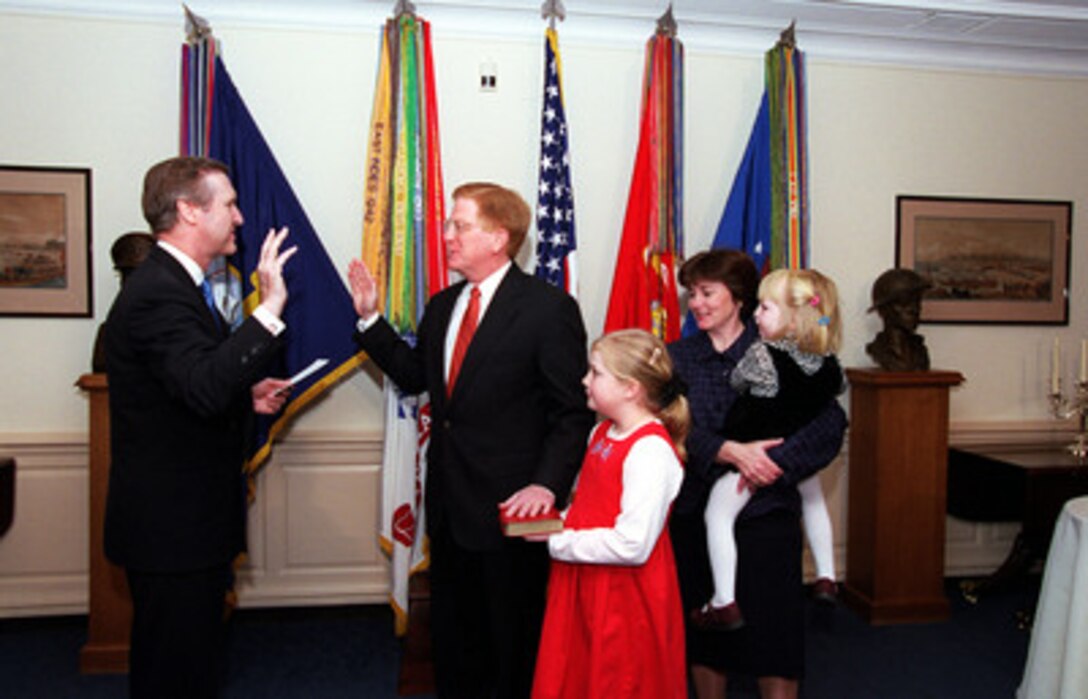 Rudy de Leon (center) is surrounded by his wife Anne (right) and their daughters Libby (with Bible) and Kerry as Secretary of Defense William S. Cohen (left) administers the oath of office to de Leon as the twenty-seventh deputy secretary of Defense in a Pentagon ceremony on March 31, 2000.  In his most recent position, de Leon served as the under secretary of Defense (Personnel and Readiness), assuming those duties in August 1997. In this capacity he was the secretary of Defense's senior policy advisor on recruitment, career development and pay and benefits for 1.4 million active duty military personnel, 1.3 million Guard and Reserve personnel and 680,000 DoD civilians. He also oversaw the Defense Health Program, Defense Commissaries and Exchanges, a Defense Education Activity and the Defense Equal Opportunity Management Institute. De Leon began his career in federal government 25 years ago and has served as Under Secretary of the Air Force, special assistant to Secretary of Defense Les Aspin and staff director for the committee on armed services of the U.S. House of Representatives. He holds a bachelor's of arts degree in history from Loyola University at Los Angeles.  