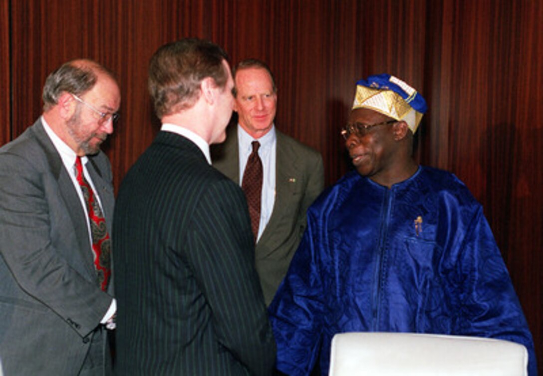 Nigerian President Olusegun Obasanjo (right) welcomes Secretary of Defense William S. Cohen (2nd from left) and members of his delegation to his presidential offices in Abuja, Nigeria, on April 1, 2000. Cohen is in Nigeria to offer U.S. assistance in raising the professionalism of the military forces of the nation. Among those accompanying Cohen during his meetings in Nigeria are: Bernd McConnell (left) deputy assistant secretary of defense for African affairs, and U.S. Ambassador to Nigeria William Twaddell (center). 
