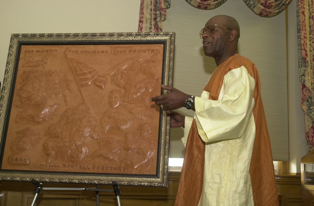 MARINE CORPS BASE CAMP LEJEUNE, N.C. - Terrence Hill, a former 82nd Airborne Division soldier, honors the Marines fighting the Global War on Terrorism by creating a specially made leather sculpture to commemorate their hard work and achievements. After spending two months making the piece it will now hang in the General John A. Lejeune Hall.