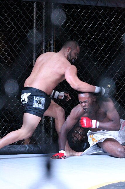 Monsuer Roberts reacts to a blow given by Junior Avilas punches during the Mixed Martial Arts Competition at Del Valle Field Oct. 22, 2010. Avilas won the fight with a knockout in the second round.::r::::n::