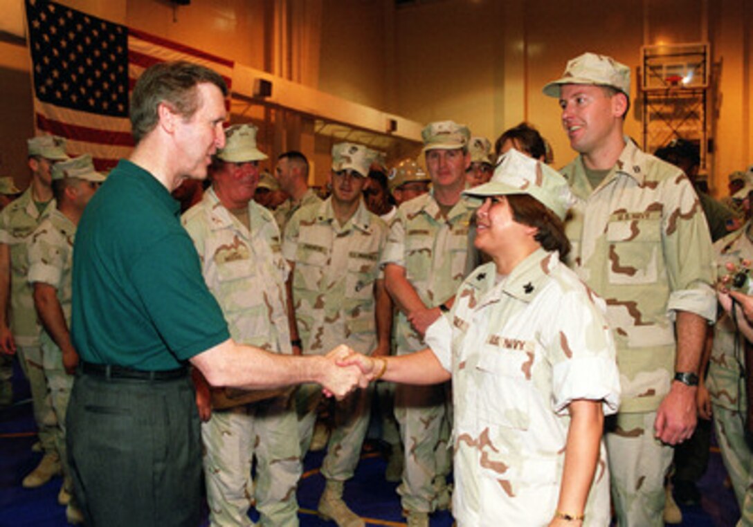 Secretary of Defense William S. Cohen (left) shakes hands with a Navy petty officer during his visit to the U.S. Naval Support Activity Southwest Asia, in Manama, Bahrain, on April 6, 2000. Cohen is in the Persian Gulf region to meet with U.S. troops stationed there and defense leaders of the Gulf region. 