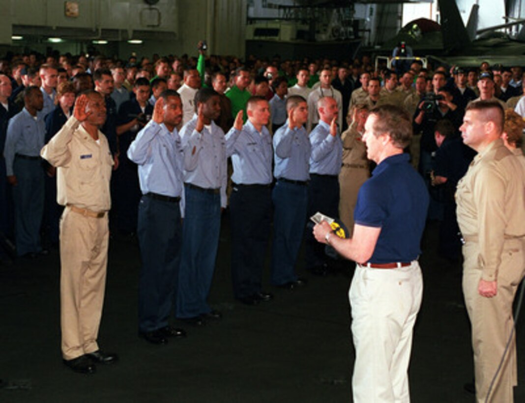 Secretary of Defense William S. Cohen (left foreground) re-enlists a group of sailors aboard the aircraft carrier USS John C. Stennis (CVN-74) as the ship operates in the Persian Gulf on April 7, 2000. Cohen is in the Persian Gulf region to meet with U.S. troops stationed there and defense leaders of the Gulf region. Stennis and its embarked Carrier Air Wing 9 are on station in the Gulf in support of Operation Southern Watch. 