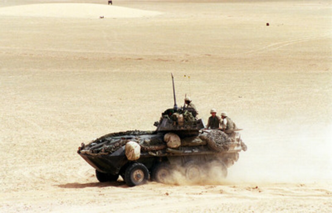 A U.S. Marine Corps Light Armored Vehicle (LAV-25) maneuvers off the range at the conclusion of a live-fire training exercise at the Udairi Training Range in northern Kuwait on April 8, 2000. The LAV-25 is an all-terrain, all-weather vehicle with night capabilities and is armed with a turret-mounted 25 mm chain gun, and a 7.62 mm machine gun. The vehicle is capable of transporting six Marines inside the hull. The LAV is attached to the 1st Light Armored Reconnaissance Battalion, 15th Marine Expeditionary Unit. 