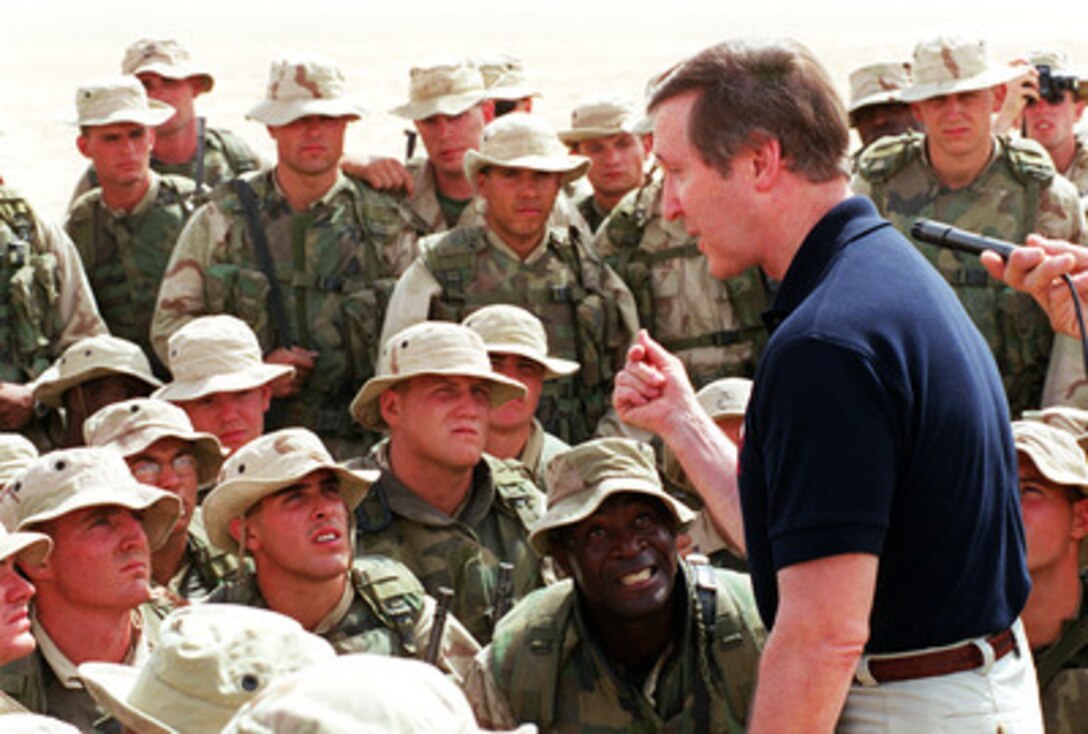 Secretary of Defense William S. Cohen talks to Marines of Charlie Company, Light Armored Vehicle Detachment, 1st Light Armored Reconnaissance Battalion following their participation in a live-fire training exercise at the Udairi Training Range in northern Kuwait on April 8, 2000. The Marines are attached to the 15th Marine Expeditionary Unit. Cohen is in the Persian Gulf region to meet with U.S. troops stationed there and defense leaders of the Gulf region. 
