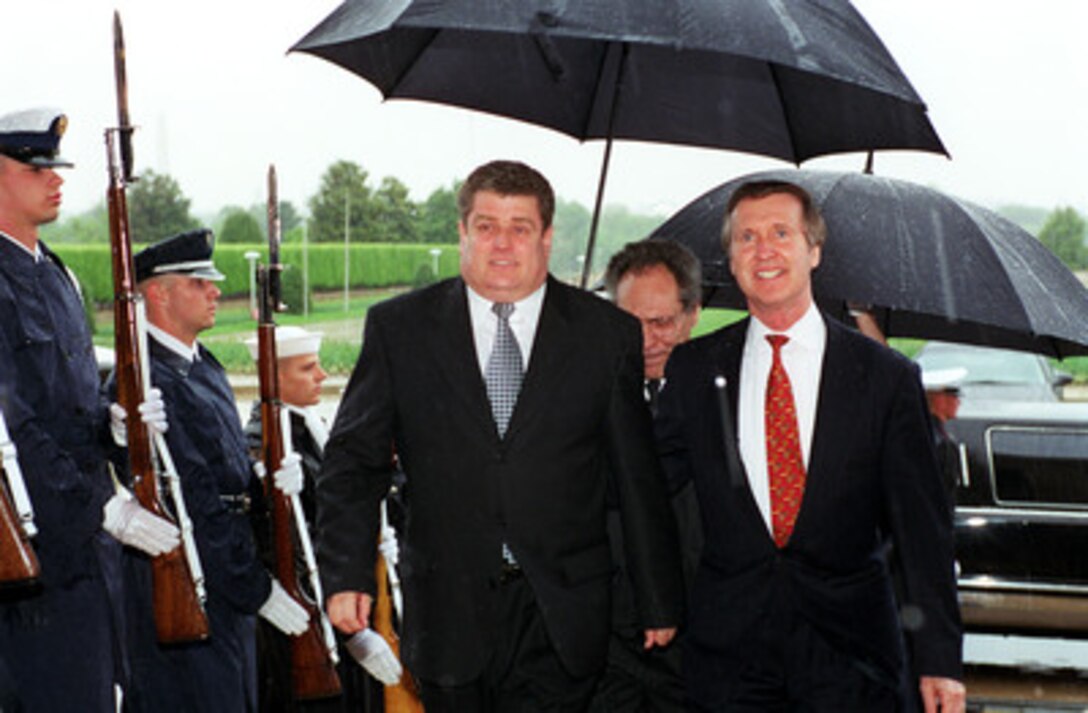 Secretary of Defense William S. Cohen (right) escorts Minister of Defense Boris Gamurari (left), of the Republic of Moldova, through an honor cordon and into the Pentagon on April 25, 2000. The two men will meet to discuss a range of security issues of interest to both nations. 