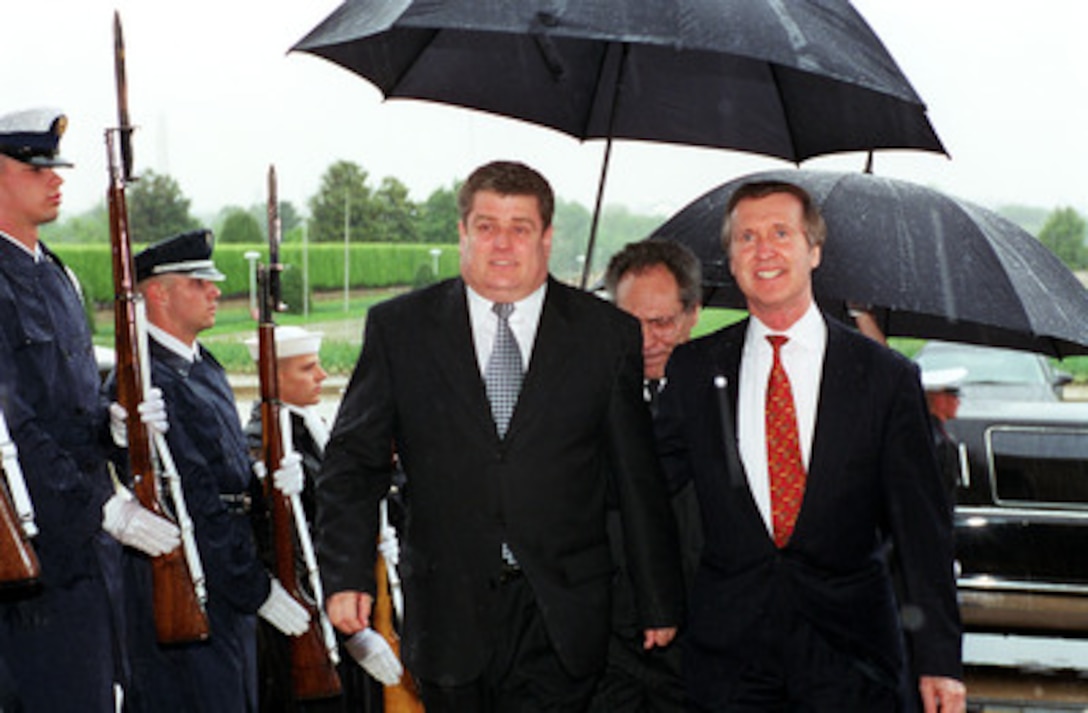Secretary of Defense William S. Cohen (right) escorts Minister of Defense Boris Gamurari (left), of the Republic of Moldova, through an honor cordon and into the Pentagon on April 25, 2000. The two men will meet to discuss a range of security issues of interest to both nations. 