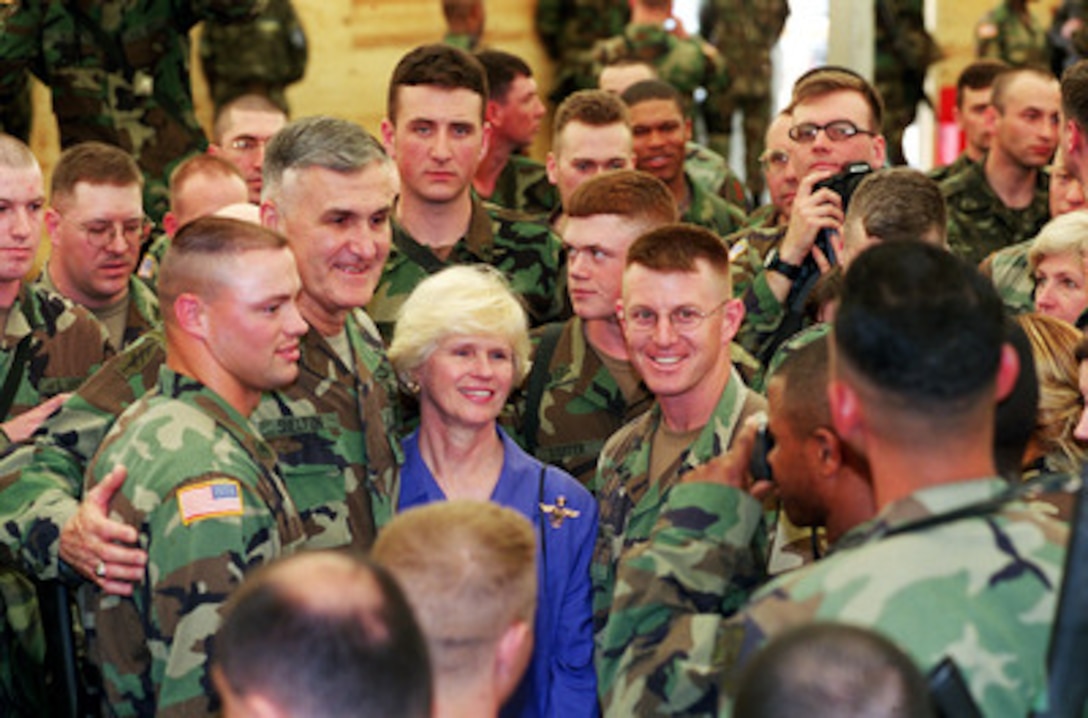 Chairman of the Joint Chiefs of Staff Gen. Henry H. Shelton, U.S. Army, and his wife Carolyn, pose for photographs with soldiers of Task Force Falcon during a troop visit to Camp Bondsteel, Kosovo, on May 1, 2000. 