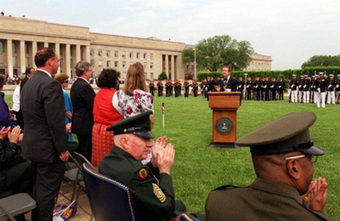 Secretary of Defense William S. Cohen applauds the "unsung heroes" in the audience as they stand during the 50th Anniversary of Armed Forces Day ceremony at the Pentagon on May 18, 2000. Cohen and Chairman of the Joint Chiefs of Staff Gen. Henry H. Shelton, U.S. Army, co-hosted the event which honored approximately 300 "unsung heroes" who are military and civilian employees of the Department of Defense in the National Capital region. 
