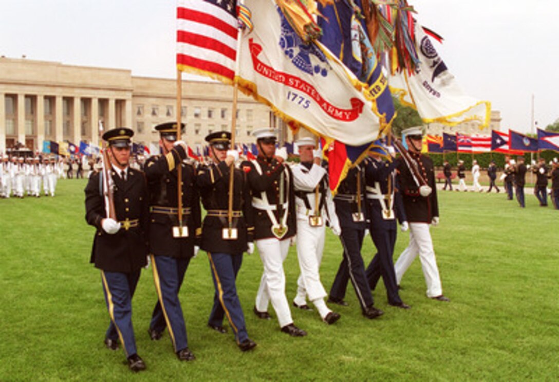 The Joint Service Color Guard passes in review before a large audience of Department of Defense officials and guests during the 50th Anniversary of Armed Forces Day ceremony at the Pentagon on May 18, 2000. Secretary of Defense William S. Cohen and Chairman of the Joint Chiefs of Staff Gen. Henry H. Shelton, U.S. Army, co-hosted the event which honored approximately 300 "unsung heroes" who are military and civilian employees of the Department of Defense in the National Capital region. 
