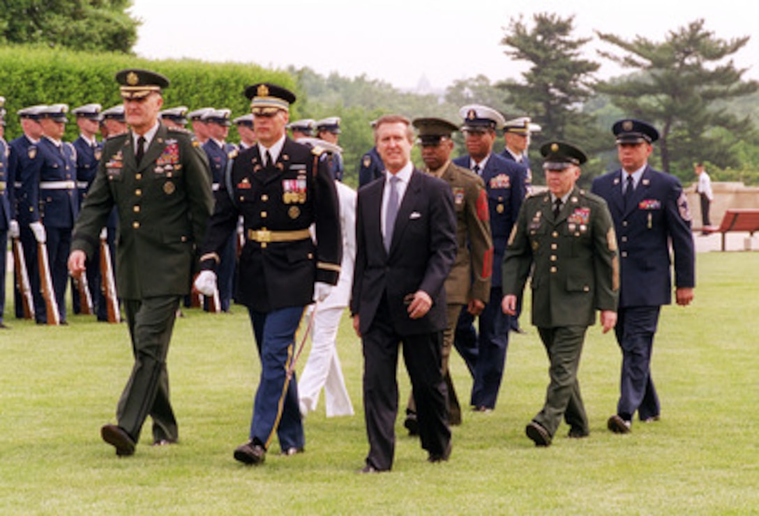 Chairman of the Joint Chiefs of Staff Gen. Henry H. Shelton (left), U.S. Army, Secretary of Defense William S. Cohen (fourth from left) and other members of the official party return from inspecting the troops during the 50th Anniversary of Armed Forces Day ceremony at the Pentagon on May 18, 2000. Cohen and Shelton co-hosted the event which honored approximately 300 "unsung heroes" who are military and civilian employees of the Department of Defense in the National Capital region. Joining Shelton and Cohen are Col. Thomas M. Jordan (2nd from left), U.S. Army; Master Chief Petty Officer Chris Penton (obscured), U.S. Navy; Cohen, Sgt. Maj. William Whaley, U.S. Marine Corps, Master Chief Petty Officer of the Coast Guard Vincent Patton II; Sergeant Major of the Army Robert E. Hall and Chief Master Sergeant of the Air Force Frederick Finch. 